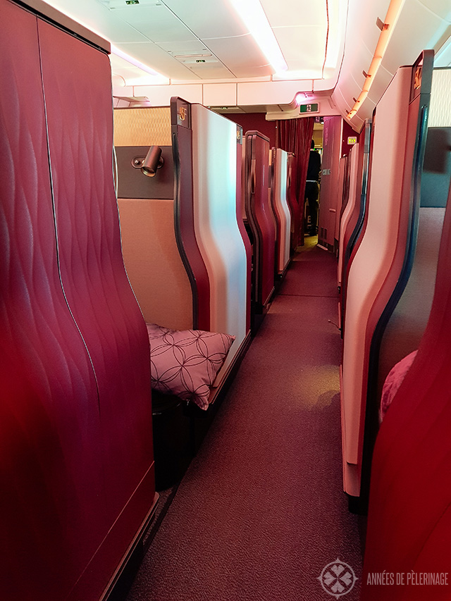 The aisle of the Qatar Airways QSuites business class MUC - DOH