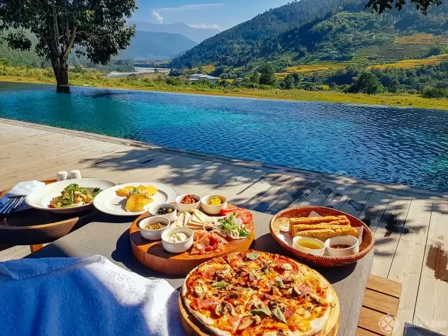 Enjoying some snacks by the poolside in Punakha