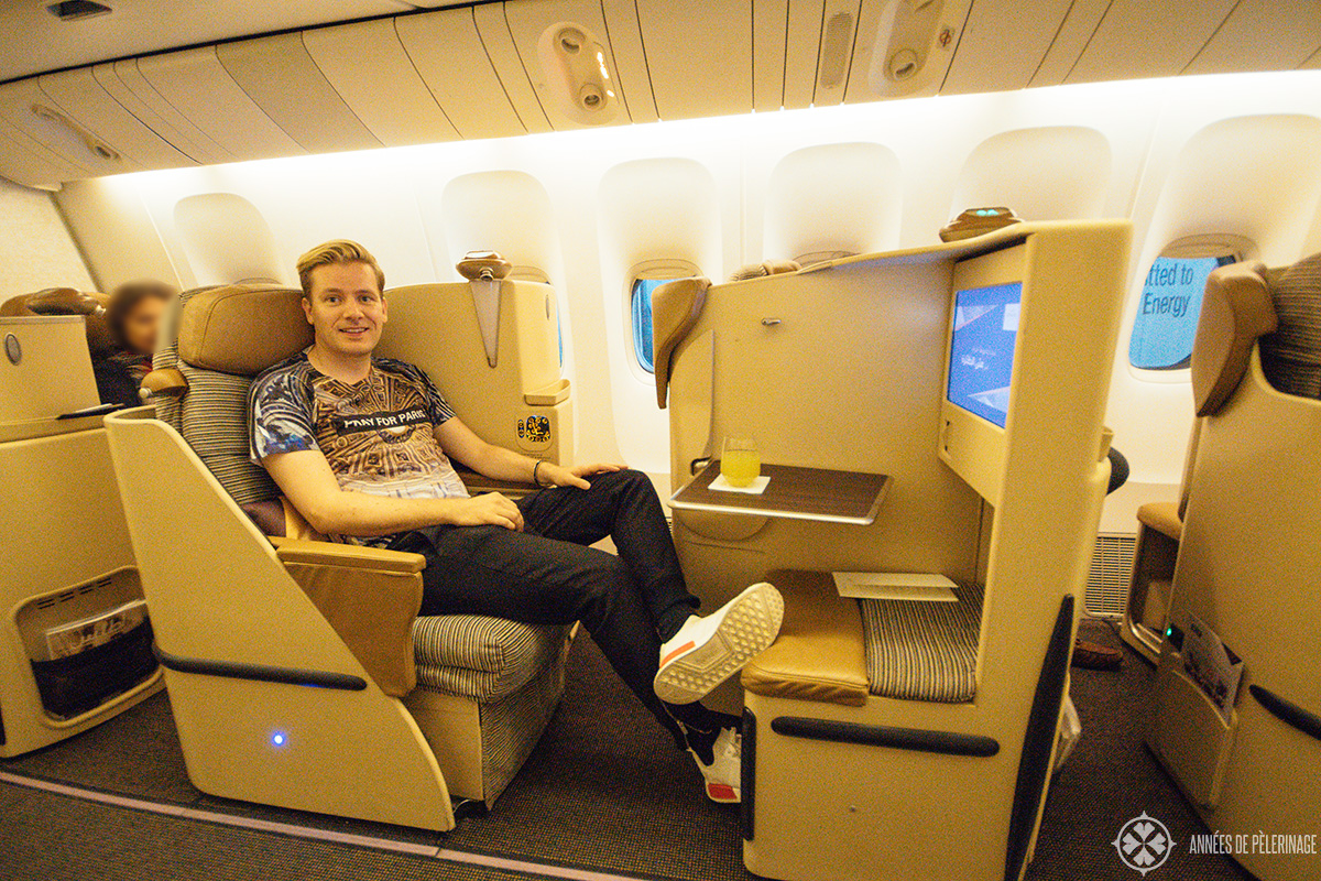 me sitting in the business class of etihad airways