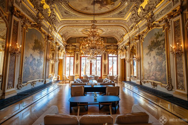 The main restaurant on the second floor of AMan Venice, with golden stucco work, chandeliers and frescos all over