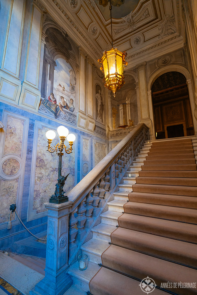 The beautiful main stair case with frescos and beautiful marble inlays and a huge lamp