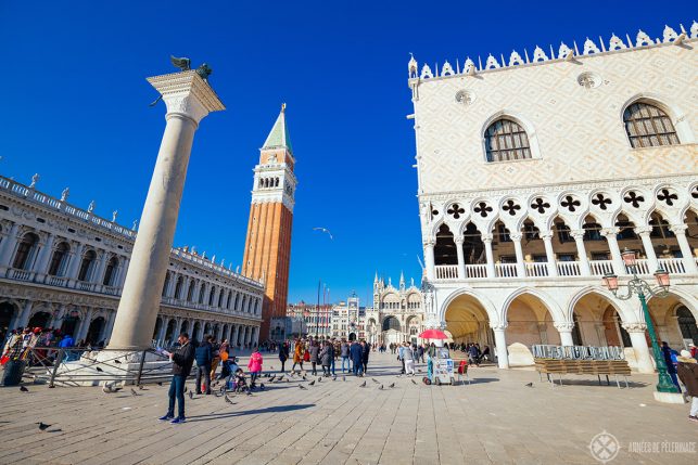 Tourists in front of the Doge Palace & St Mark's square in Venice on a bright sunny day