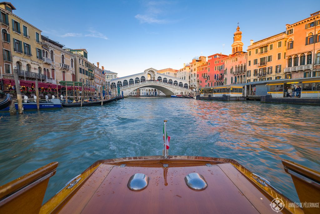 View of the Rialto bridge from a water taxi in venice
