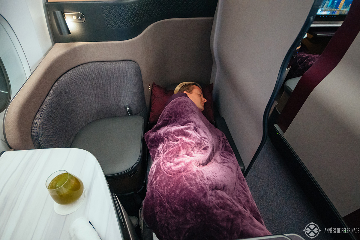 Me sleeping in the qsuites of qatar airways business class