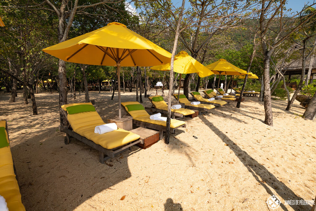 view of the sun lounges at the main beach of the Six Senses Ninh Van Bay