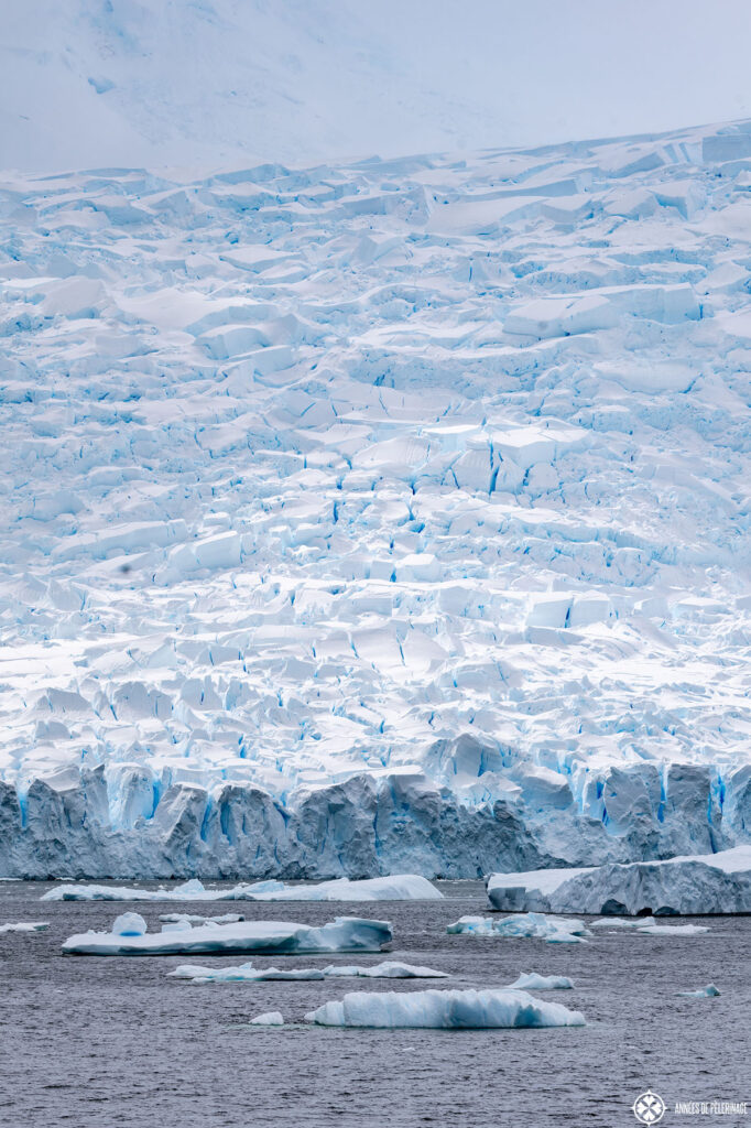 a towering wall of ice from a huge antartic glacier
