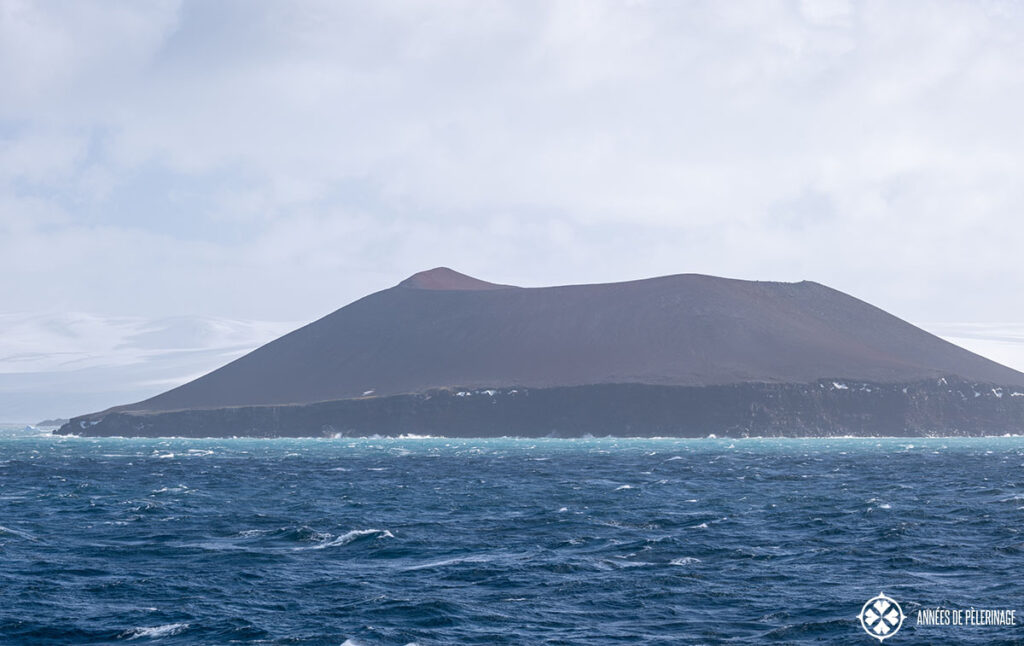 very rough sea around a caldera island in antartica
